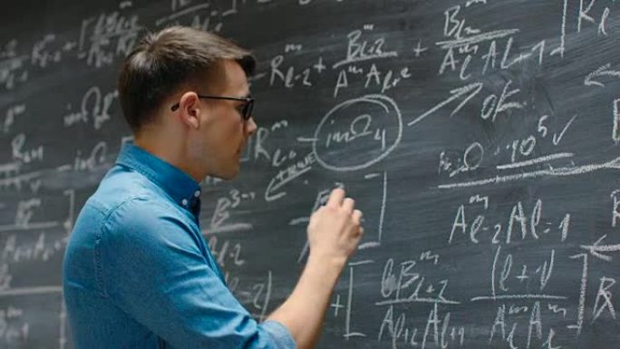 才华横溢的年轻学者在黑板上写了又大又复杂的数学公式/方程式。