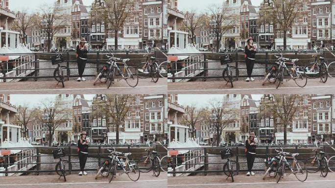美丽的高加索女人结束电话。街头摄影师用自行车在河桥上与她的朋友交谈。4K