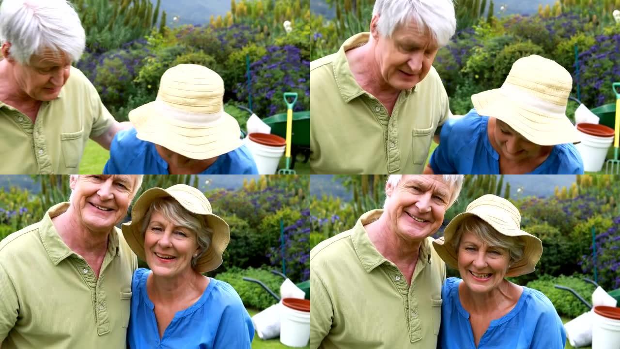 微笑的高级夫妇一起站在花园里
