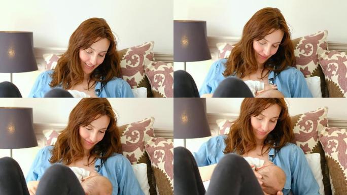 年轻的妈妈坐在床上在卧室4k母乳喂养婴儿
