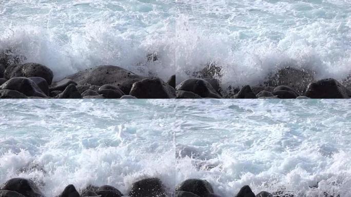 慢动作特写: 白色海浪撞击并溅到火山岩上