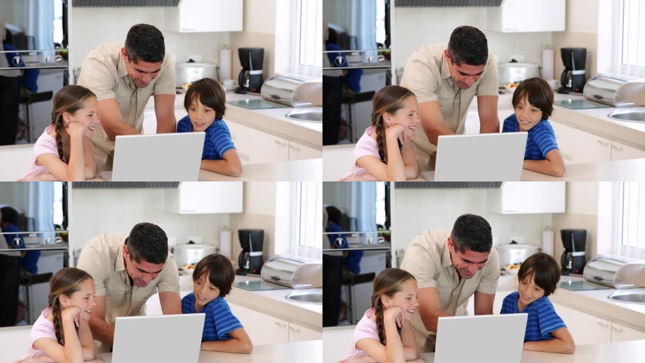 父亲和他的孩子一起使用笔记本电脑