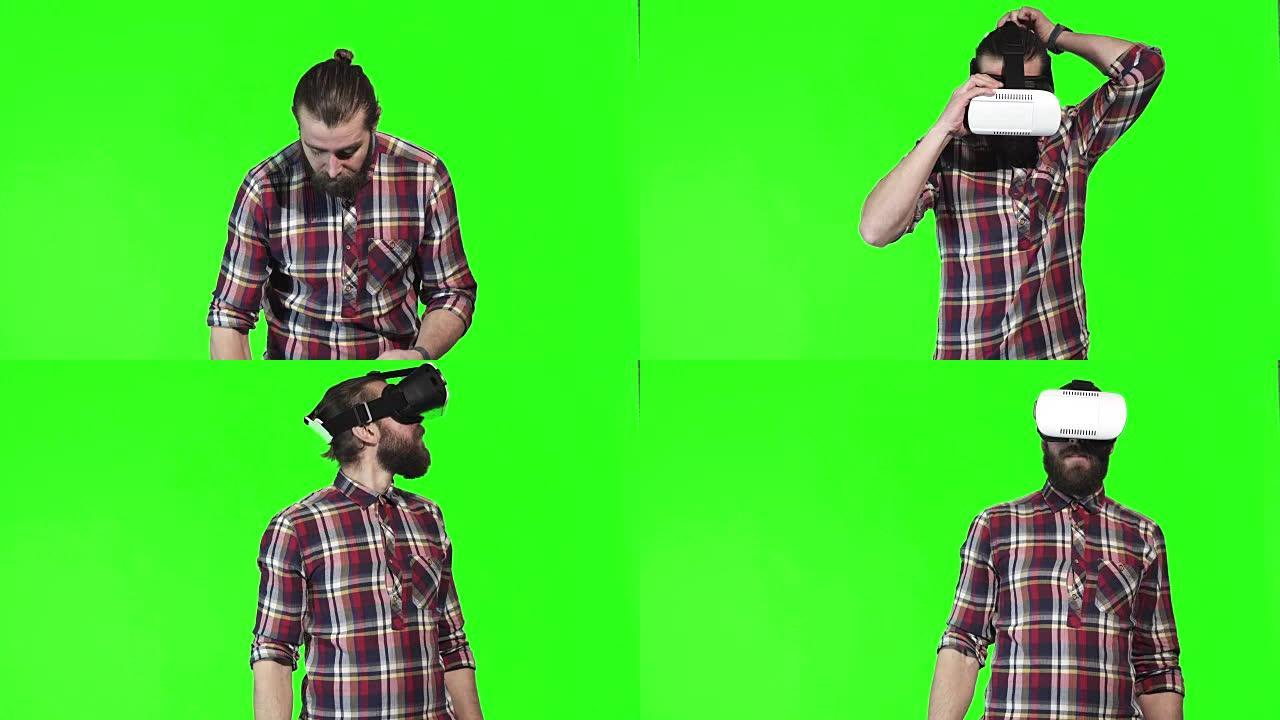 大胡子男子在绿屏上戴着VR谷歌