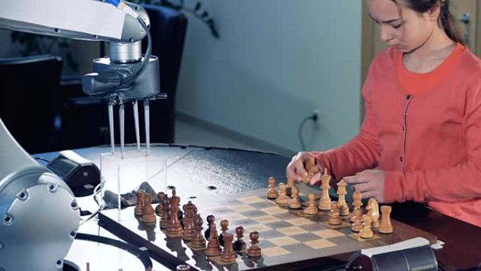 小女孩为和机器人下棋准备棋盘。