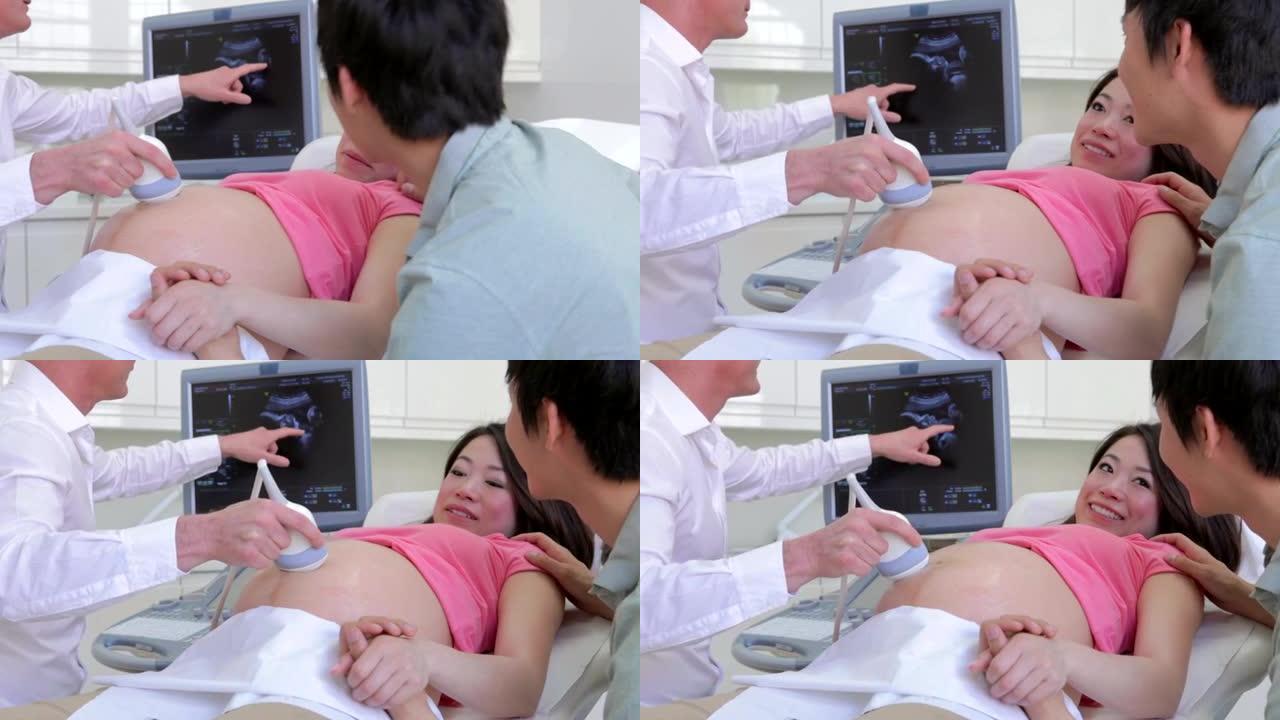 孕妇和患有超声波的伴侣的特写