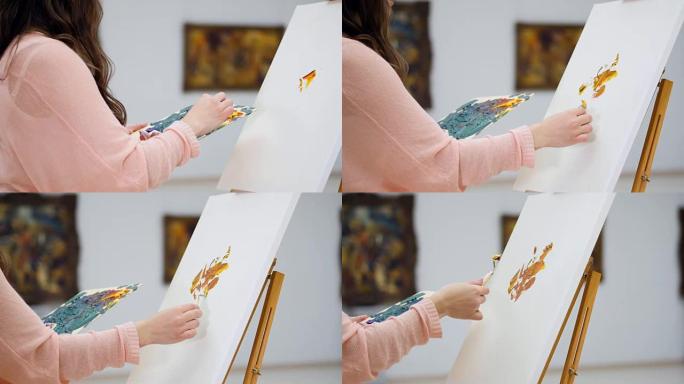 女画家，艺术家开始绘画，将画布接地。特写。4K。