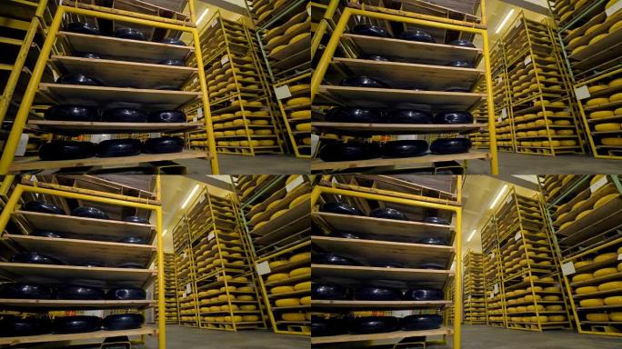 一个大的储藏室，架子上装满了用黑色和黄色蜡覆盖的奶酪轮。4K。