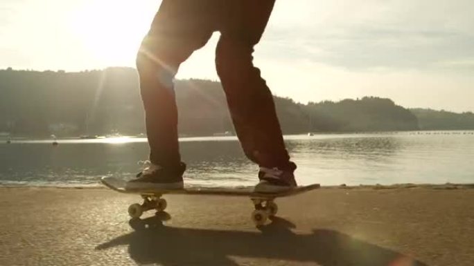 慢动作特写: 溜冰者在金色的日落时分做跳跃动作