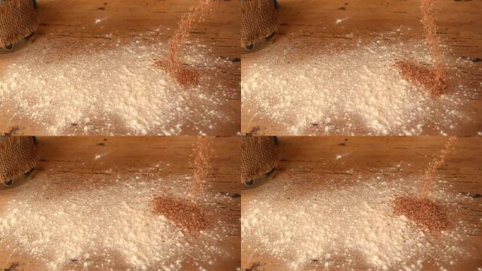 面粉和麸皮洒在木制工作表面上