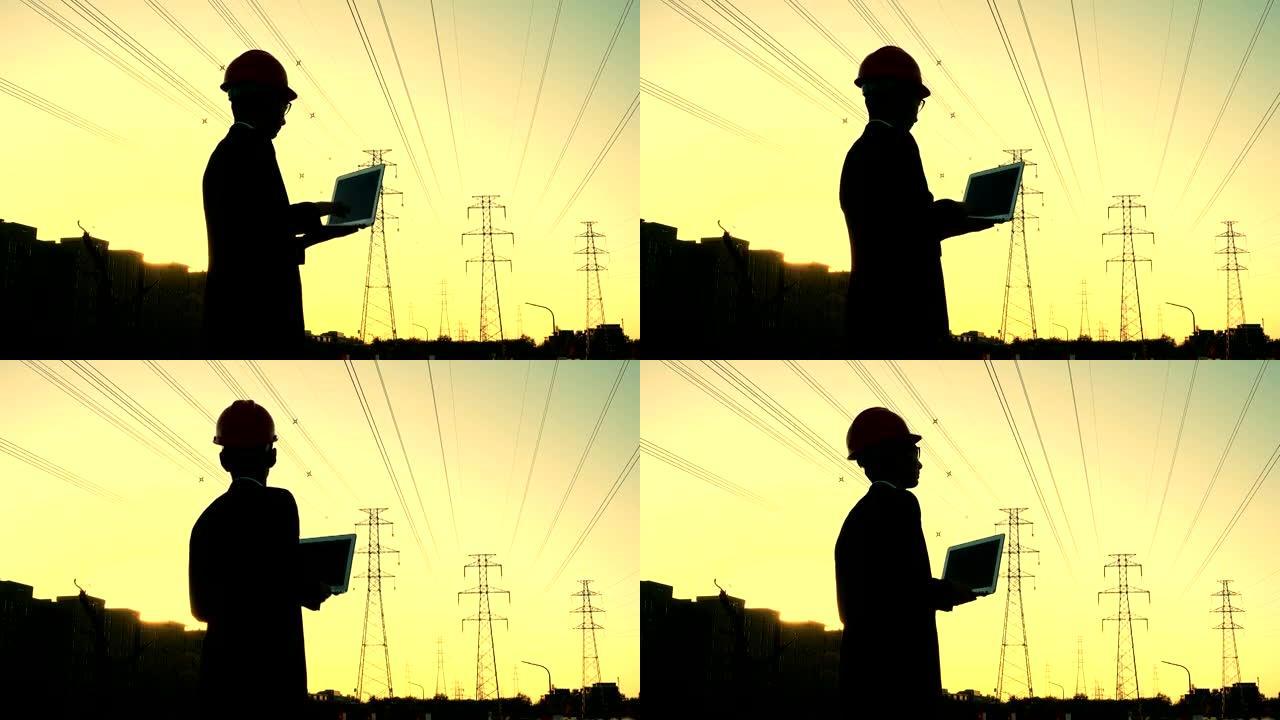 工程师在日落时使用笔记本电脑