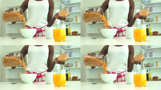 女人在早餐时倒麦片