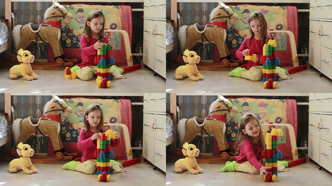 可爱的小女孩在家里玩玩具积木
