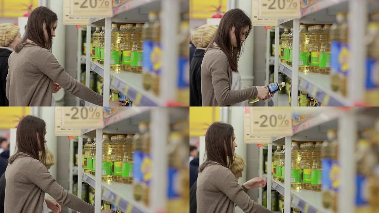 年轻女子在商店里选择葵花籽油