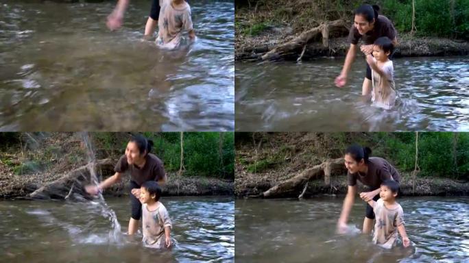 男婴和母亲一起在小溪玩耍。