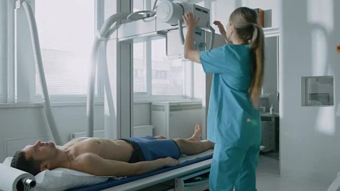 在医院里，男子躺在床上，女技师调整x光机。拥有技术先进的医疗设备和专业人才的现代化医院。