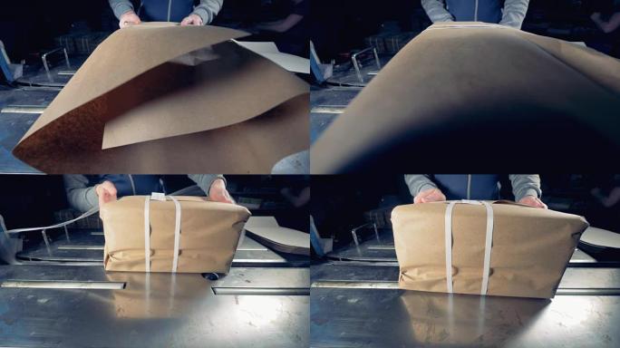 女用手将产品包装到工厂的纸盒中。