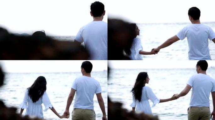 迷人的健康夫妇一起在海滩上跳舞很开心。