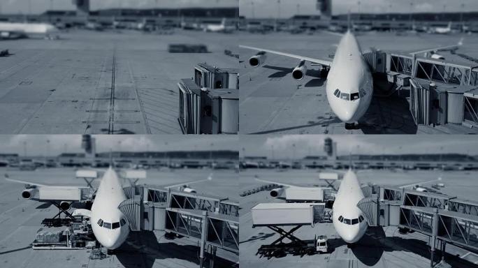 机场车辆和工人在机场以黑白换装站立飞机的时间流逝