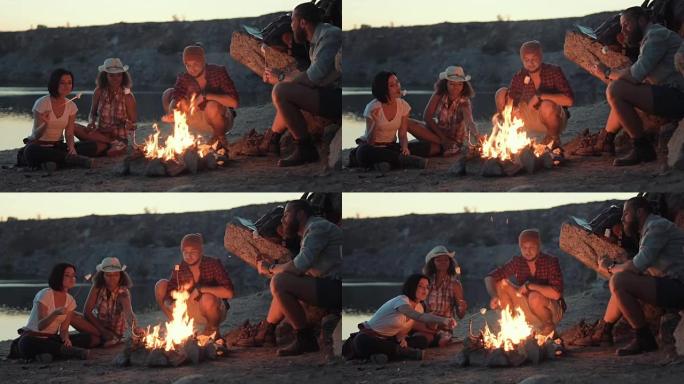 旅行者在岸上的篝火上放松