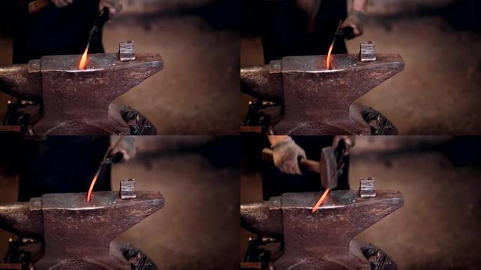 铁匠用铁锤在铁炉铁砧上工作。工作场所的特写视图