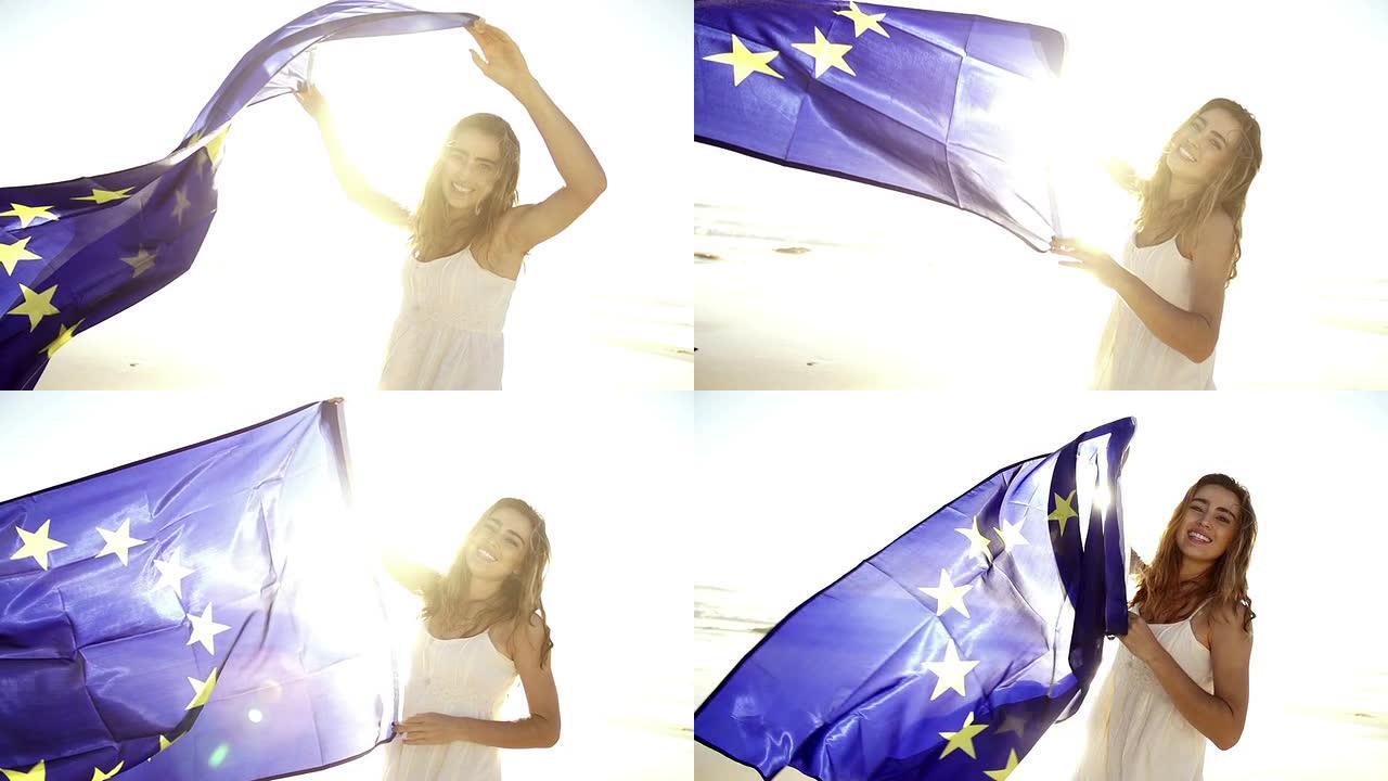 快乐的女人挥舞着欧洲国旗，对着镜头微笑