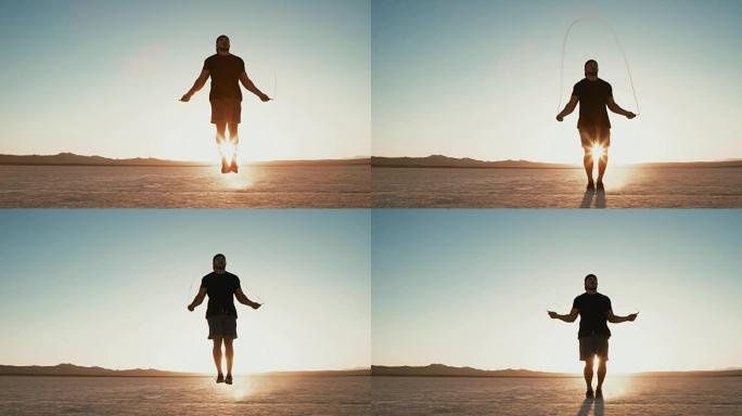 慢动作运动员在日落时在沙漠外面锻炼跳绳
