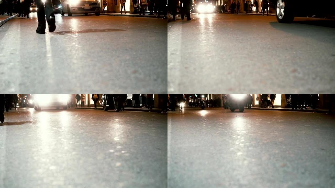 晚上在市中心的道路特写。摩托车和人匆匆忙忙，深夜走。慢动作