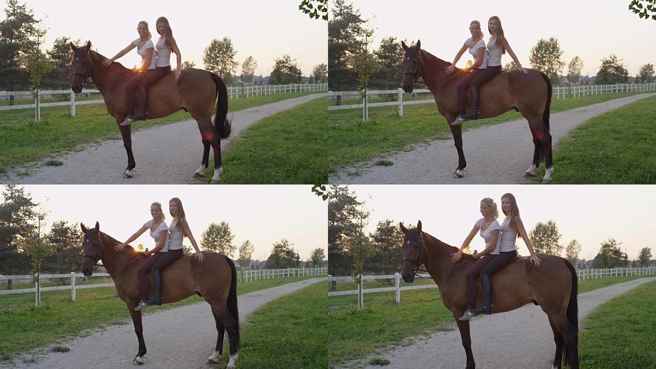 特写: 两个漂亮的女孩在日出时在牧场上骑着漂亮的马