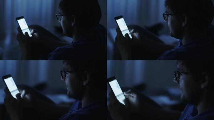 男人晚上在Android手机上输入消息