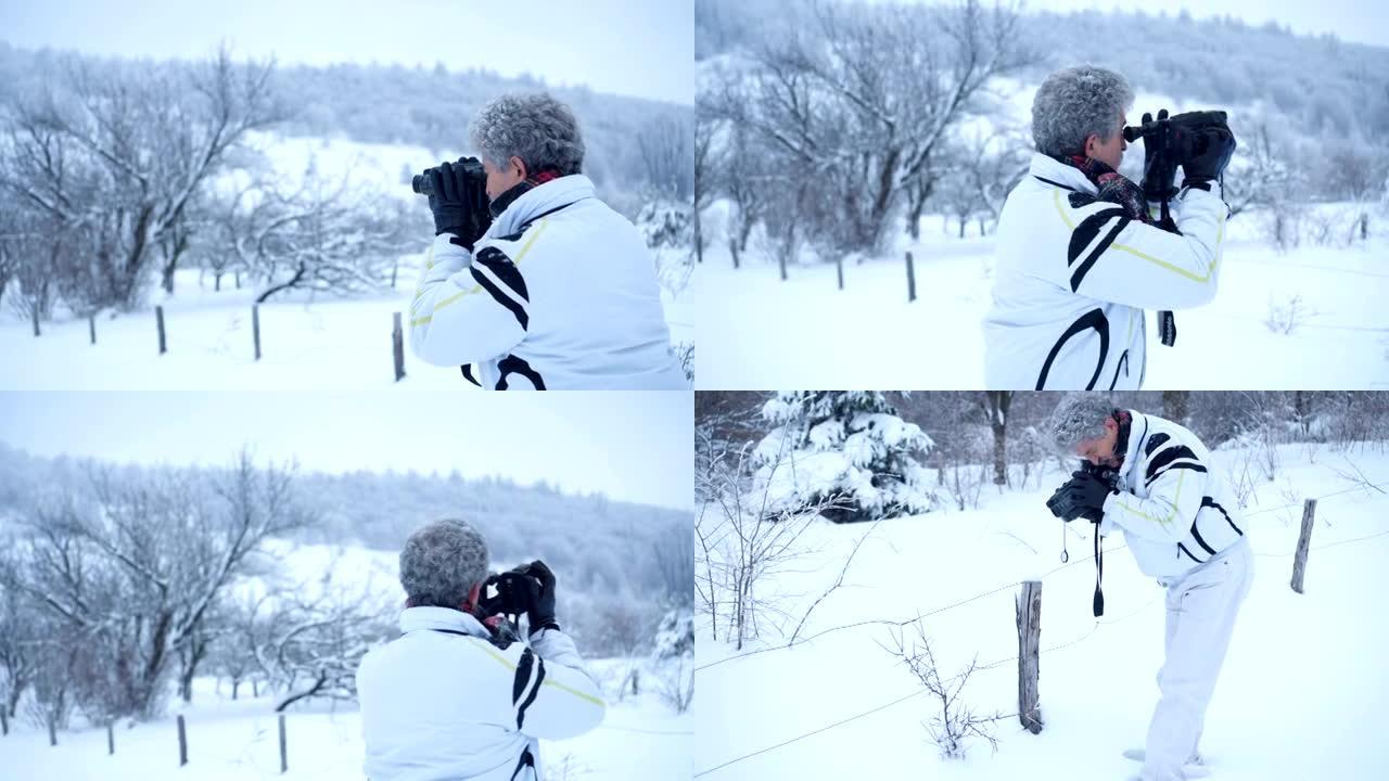 拍摄冬季自然的高级男子