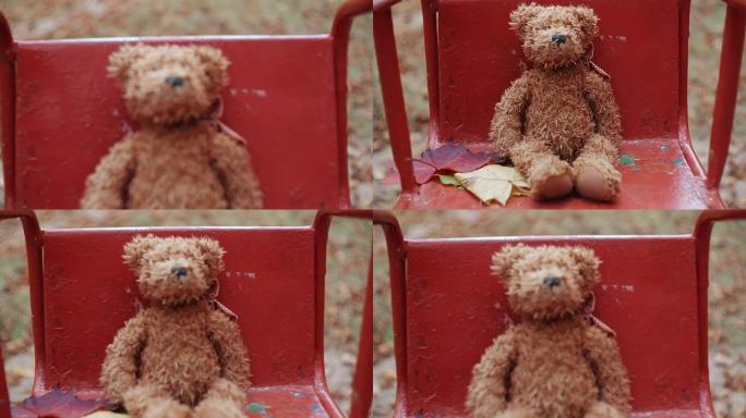 棕色泰迪熊在秋季公园FullHD的旧秋千上摇摆