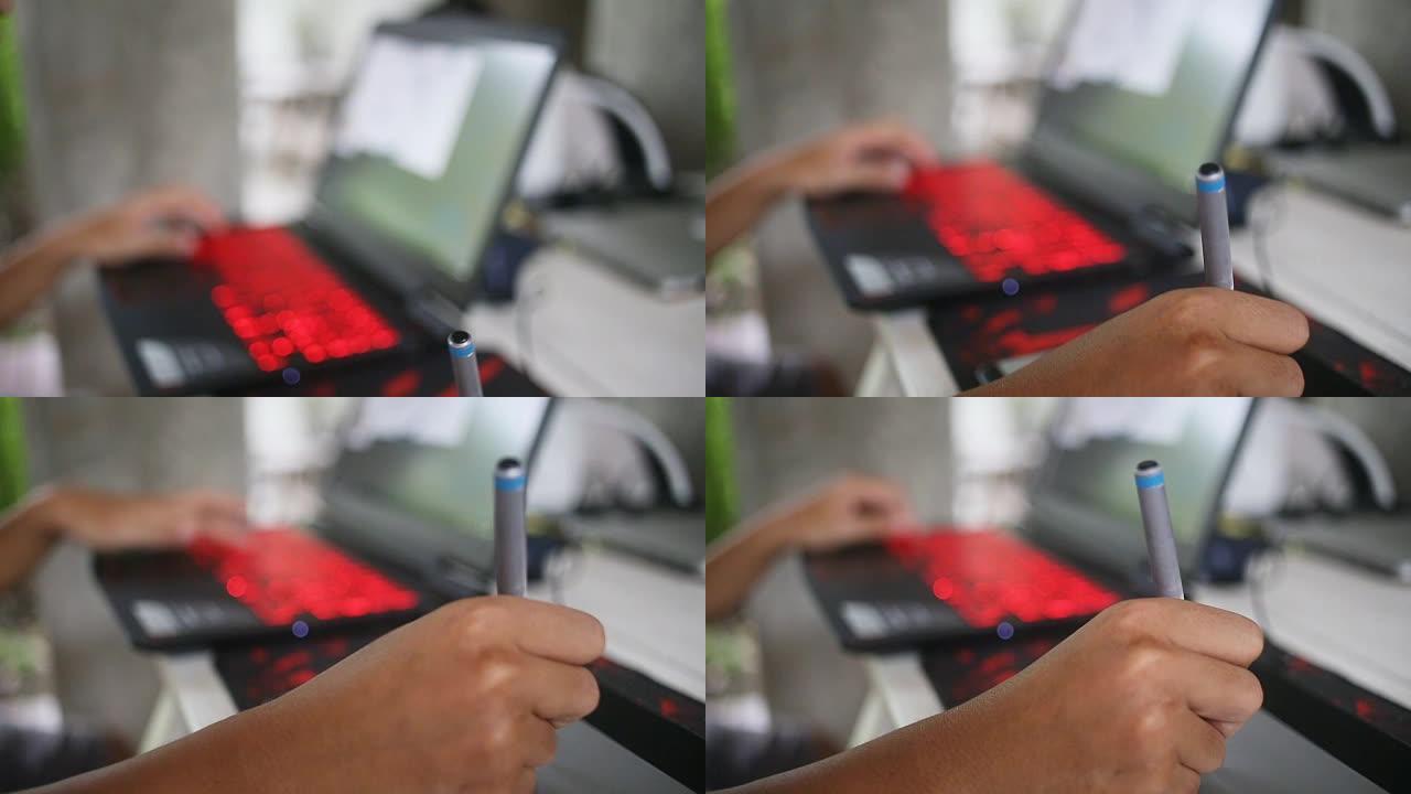 设计师将图形平板电脑与笔记本电脑一起使用。