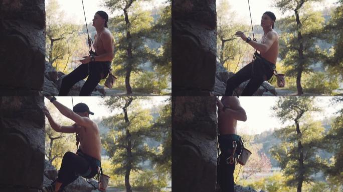 攀登者吊着绳子从悬崖上跳下来