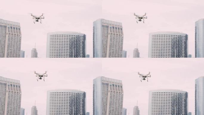 四轴飞行器无人机，云台上的摄像头在城市的天空中飞行，以慢动作拍摄