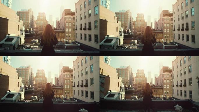 站在屋顶上的美丽红发女人的后景照片。纽约市的城市景观，拥有巨大的摩天大楼和建筑。