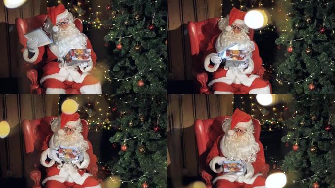 圣诞老人打包一个礼品盒，坐在圣诞树附近的椅子上。
