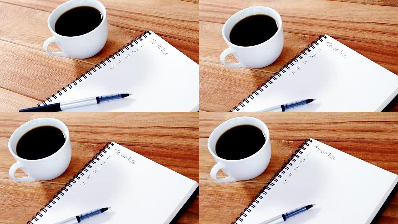 带日记和钢笔的咖啡杯特写