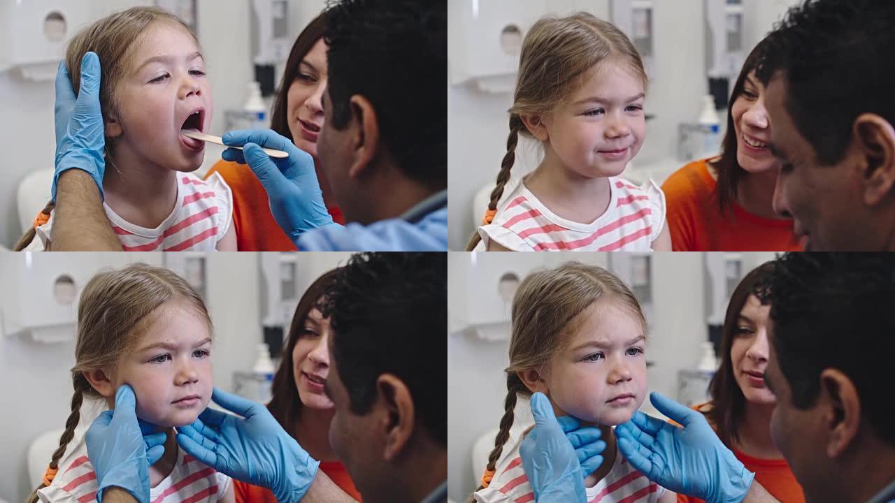 : 医生检查小女孩的喉咙痛