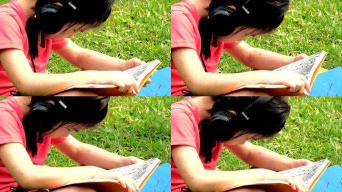 女孩看书和听音乐。