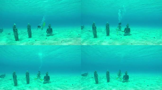 水下: 年轻的潜水员在水下游泳和浮潜，探索梦幻般的波拉波拉岛泻湖海底的沉没雕像保护区