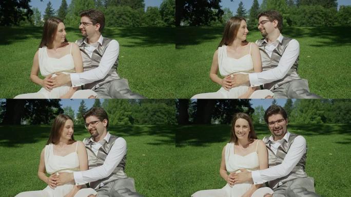 慢动作: 充满爱心的新婚夫妇在公园的晴天轻轻抚摸怀孕的肚子