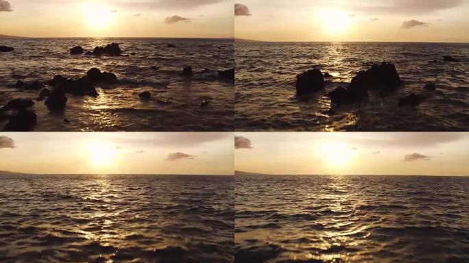 惊人的戏剧性日落景色。空中射击在夏威夷的海洋上空低空飞行