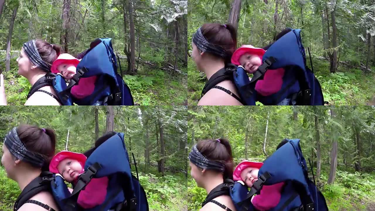 母亲在森林中行走时用背带背包背着婴儿4k