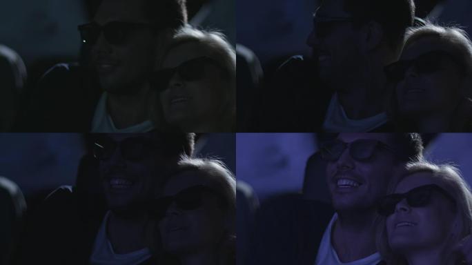 一对夫妇在电影院观看5d电影放映时互相拥抱的特写镜头。