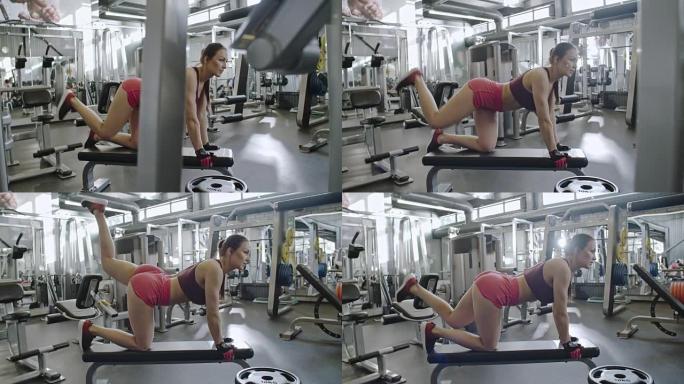 女运动员在健身房做抬腿运动