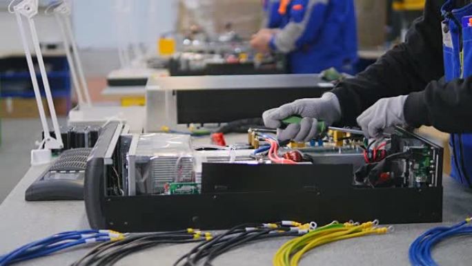 计算机，工厂工人正在组装的电气设备。
