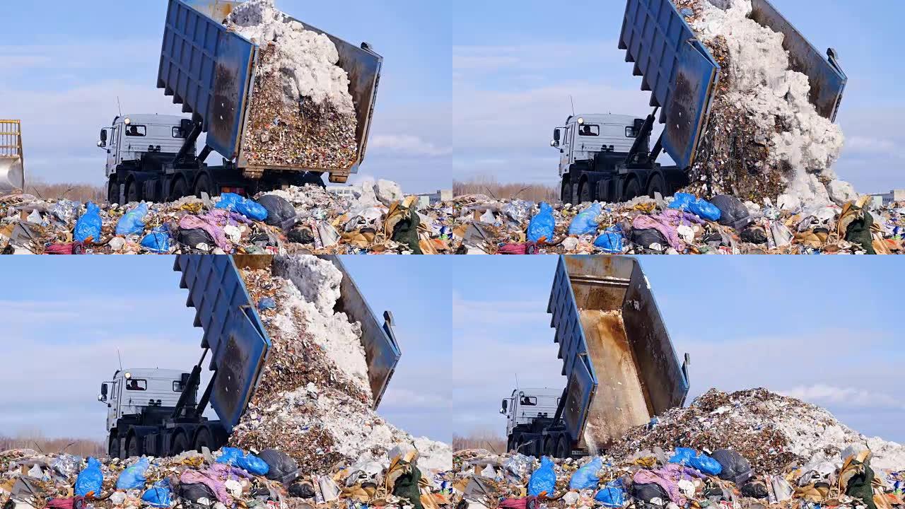 垃圾车在垃圾填埋场处理垃圾。运输垃圾到废物的车辆。