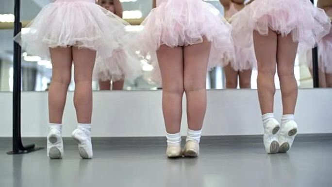 站在芭蕾巴雷旁边的小女孩