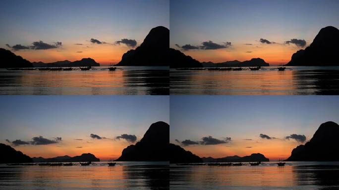 日落时带有传统菲律宾船只的热带景观。菲律宾