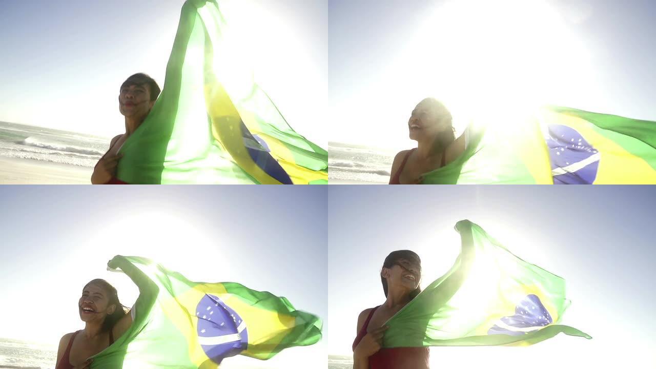女人在慢动作的海滩上挥舞着巴西国旗